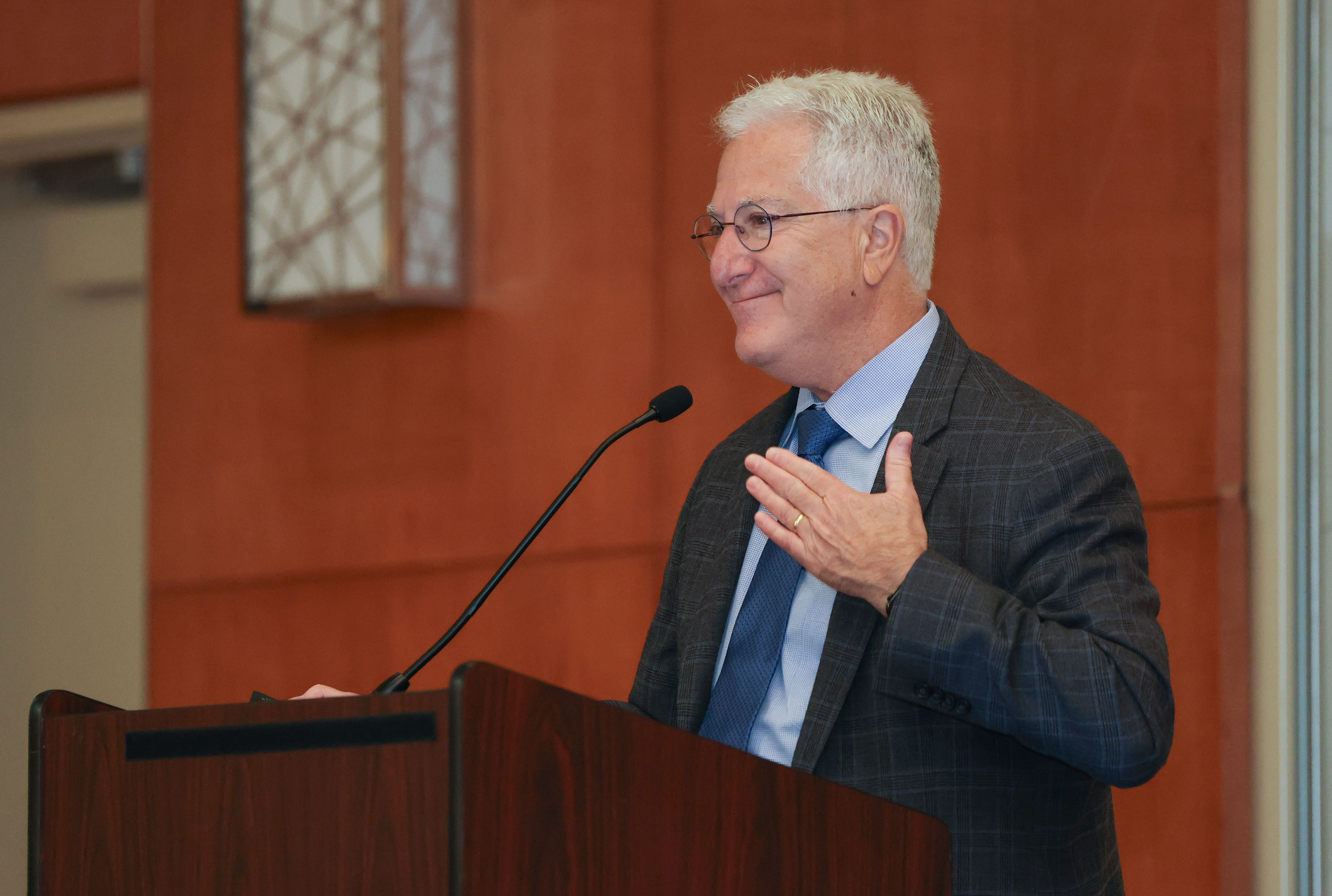 Members of the Quality of Life Symposium panel clap during the 2024 event.